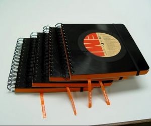 three notebooks stacked on top of each other with pencils sticking out of them