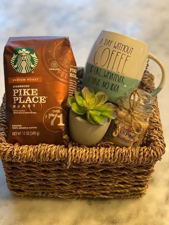 a basket filled with coffee, tea and other items sitting on top of a table