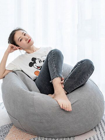 a woman sitting on a bean bag chair