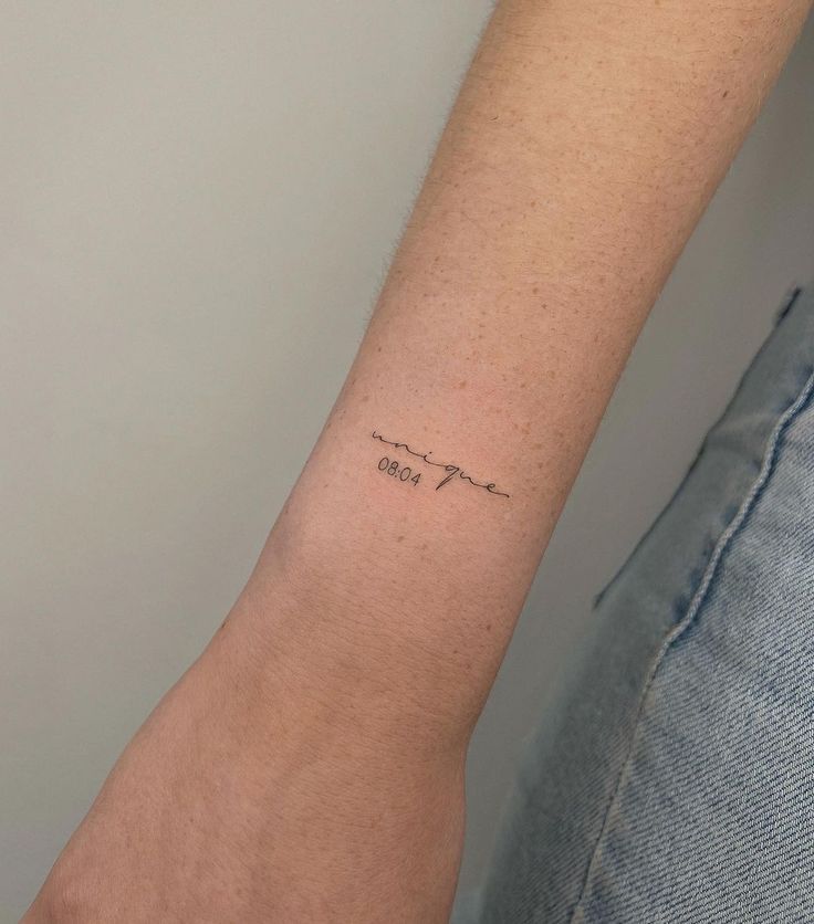 a person's arm with a small tattoo on it that reads, i love you