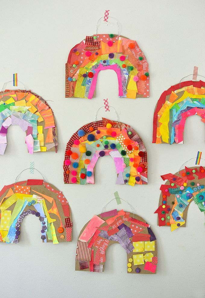 several pieces of art made out of construction paper and colored papers are arranged in the shape of rainbows