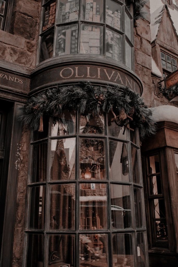 a black and white photo of the outside of an old building with wreaths on it