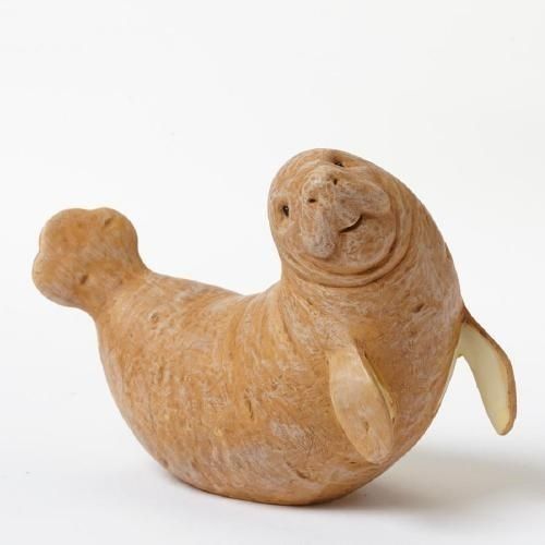 a small wooden toy seal on a white background