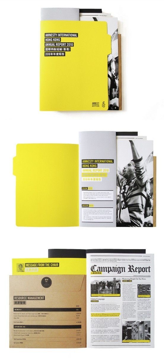 an open book with yellow pages and black text on it, sitting next to two folders