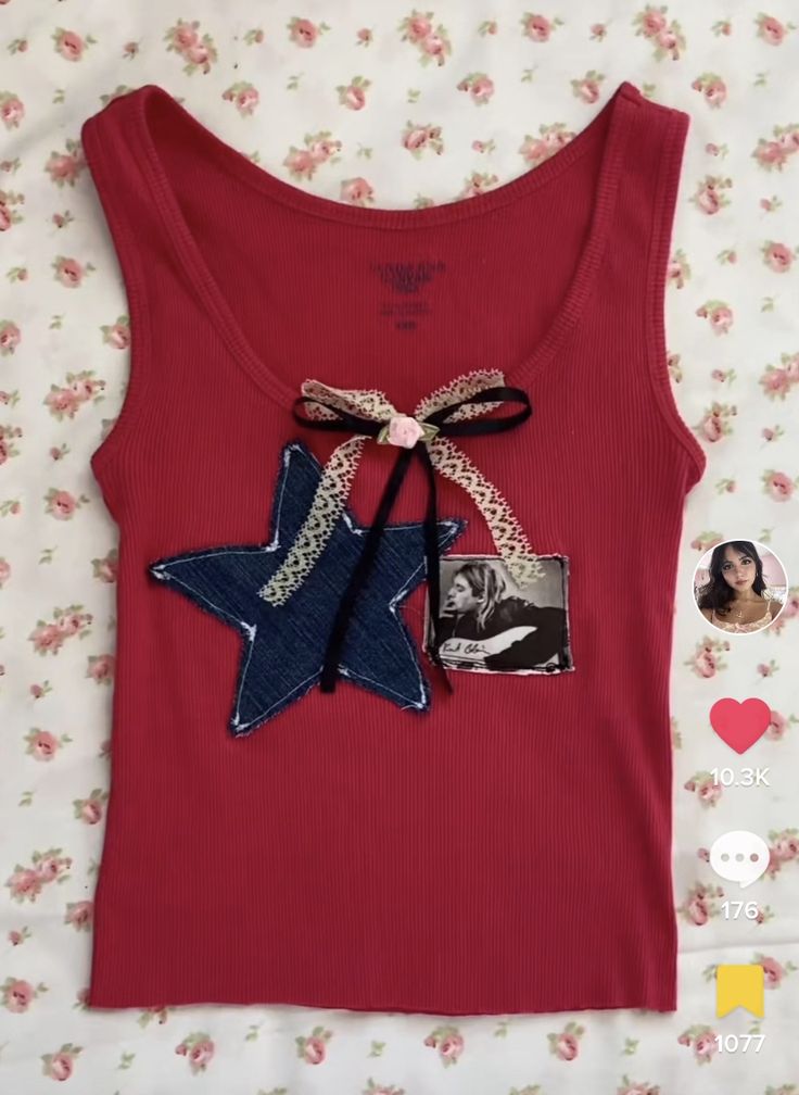 a red tank top with a blue star on the front and a black bow at the back