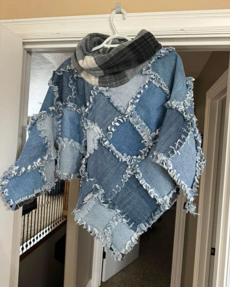 an old jacket hanging on a door with a scarf draped over it's shoulders