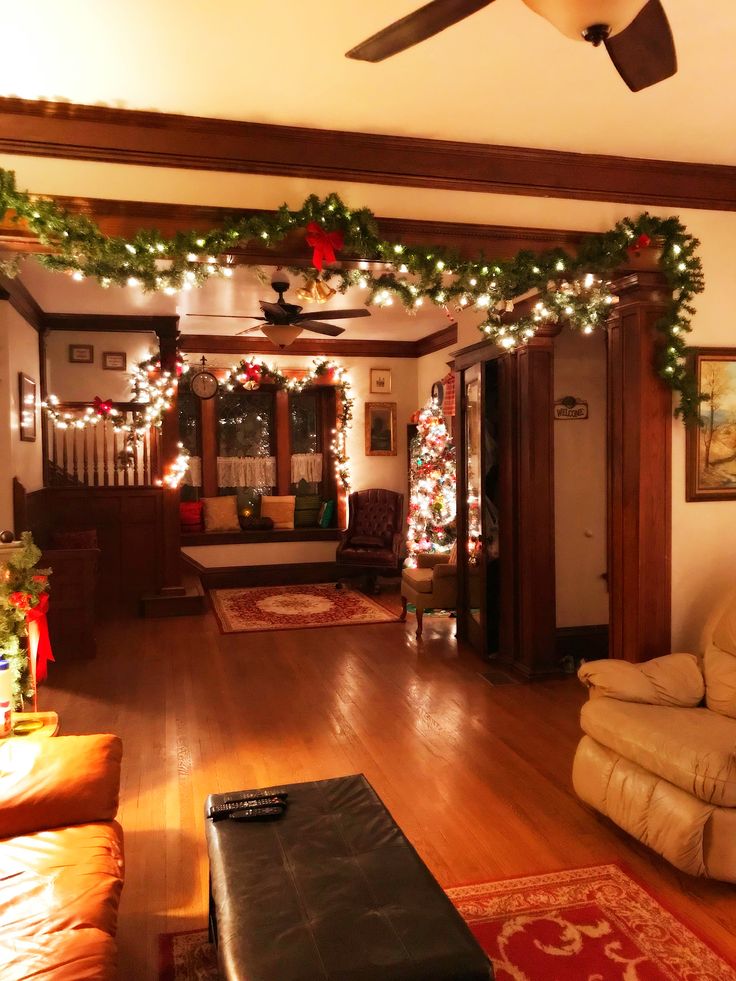 the living room is decorated for christmas with garland and lights