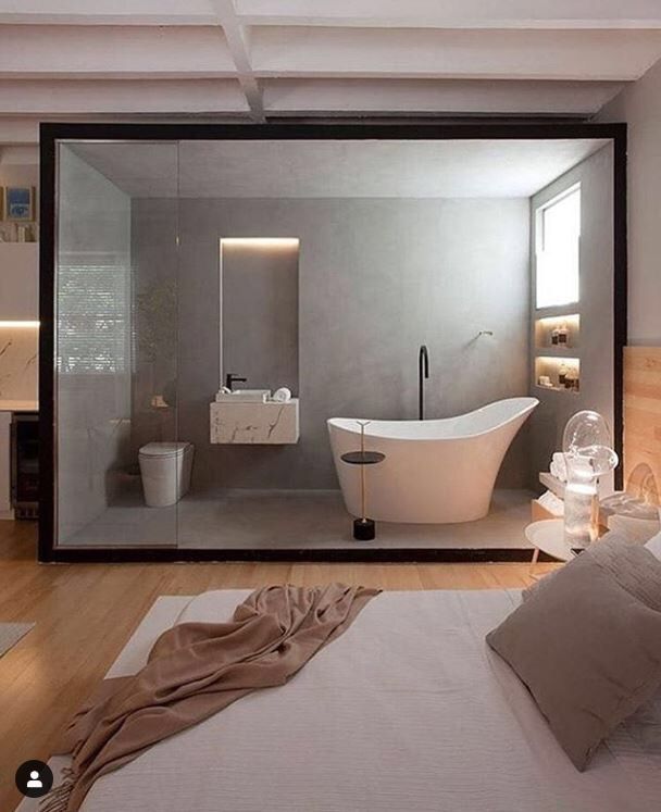 a white bath tub sitting inside of a bathroom