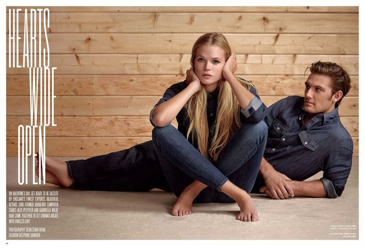 a man and woman sitting on the floor next to each other with their hands behind their heads