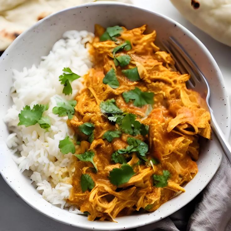 a white bowl filled with rice and chicken curry