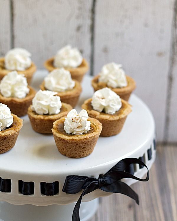 small cupcakes with white frosting on a cake stand