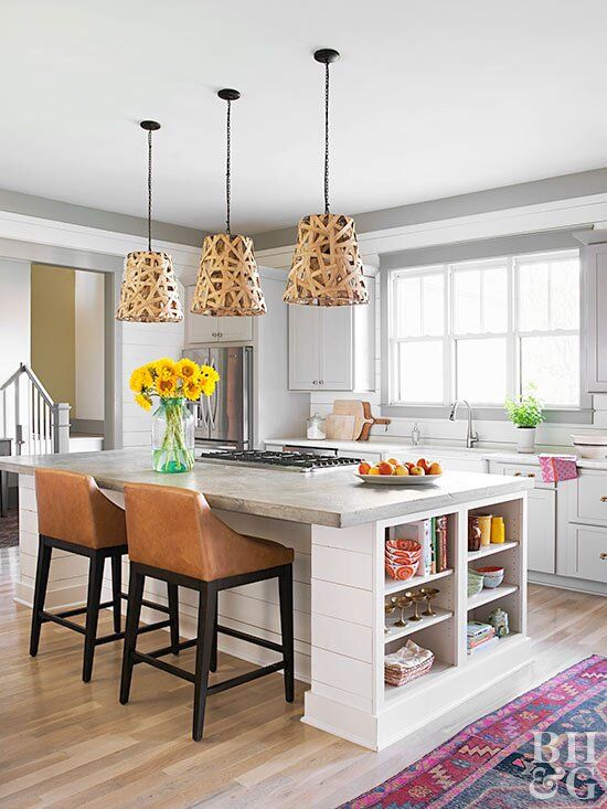 a kitchen with an island and chairs in it