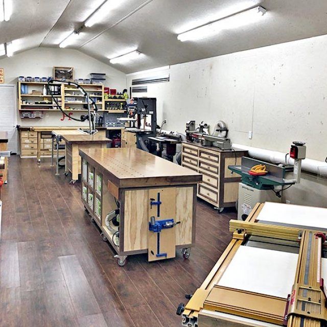 a room filled with lots of workbenches and tables covered in wood planks