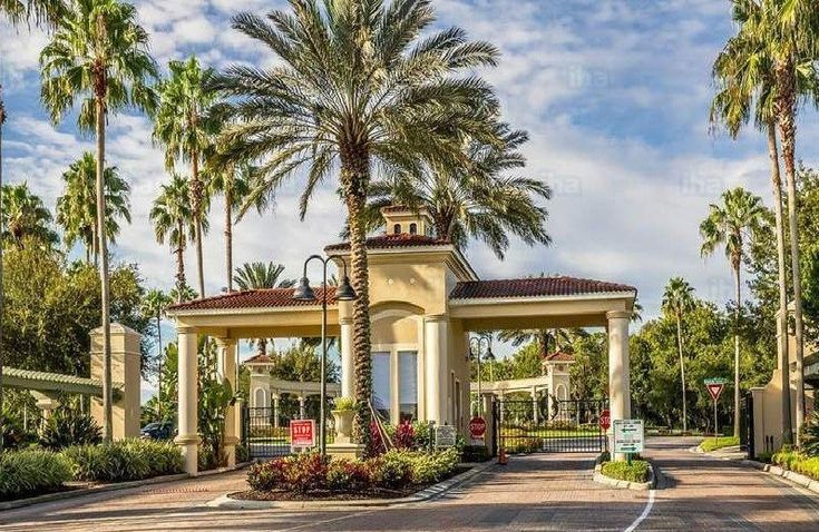 the entrance to an apartment complex with palm trees