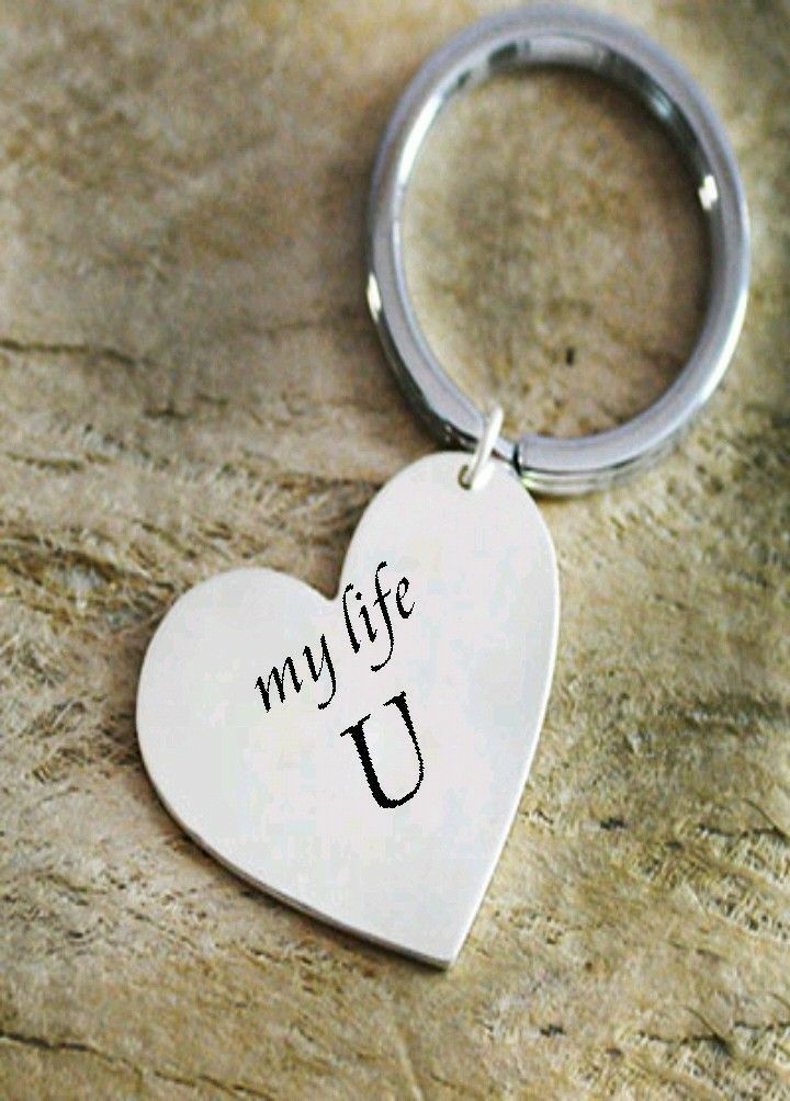 a heart shaped keychain with the words my life u on it