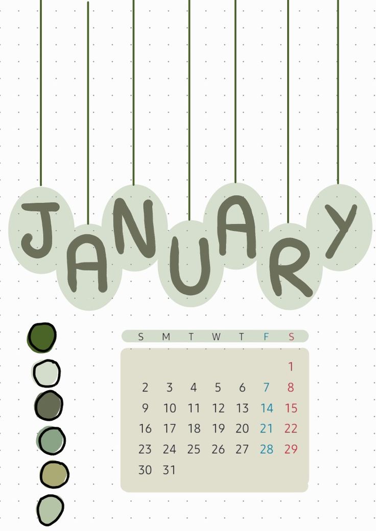 a calendar with the word january hanging from it's strings and some green leaves