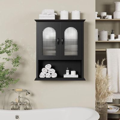 a white bath tub sitting next to a wall mounted cabinet