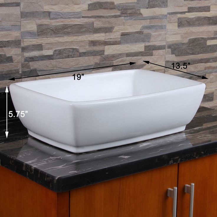 a square white sink sitting on top of a counter next to a black countertop