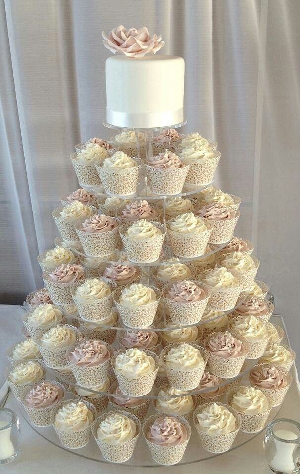 a wedding cake made out of cupcakes on a table