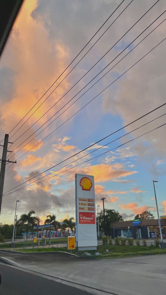 a shell gas station with power lines above it