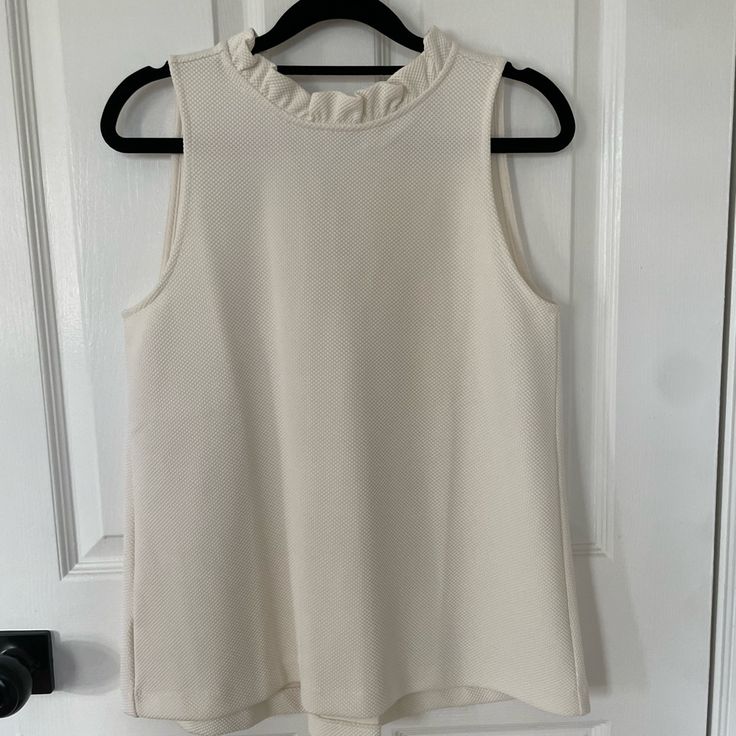 Beautiful Ann Taylor Navy Blue Sleeveless Top With V In The Back And Pleating. I Am Also Selling In Navy - They Are Gorgeous And I Am Hesitant To Part With Them But I Haven’t Worn Them Yet And Need To Declutter. Very Substantial Fabric. Size Xs. Chic Cream Tank Top, Chic White Tank Top For Work, Sleeveless Cream Top With Ruffles, Cream Sleeveless Top With Ruffles, White Stretch Tank Top With Ruffles, Feminine Sleeveless Off White Top, Chic Cream Sleeveless Blouse Tank Top, Chic Cream Sleeveless Tank Top, Chic White Ruffled Tank Top