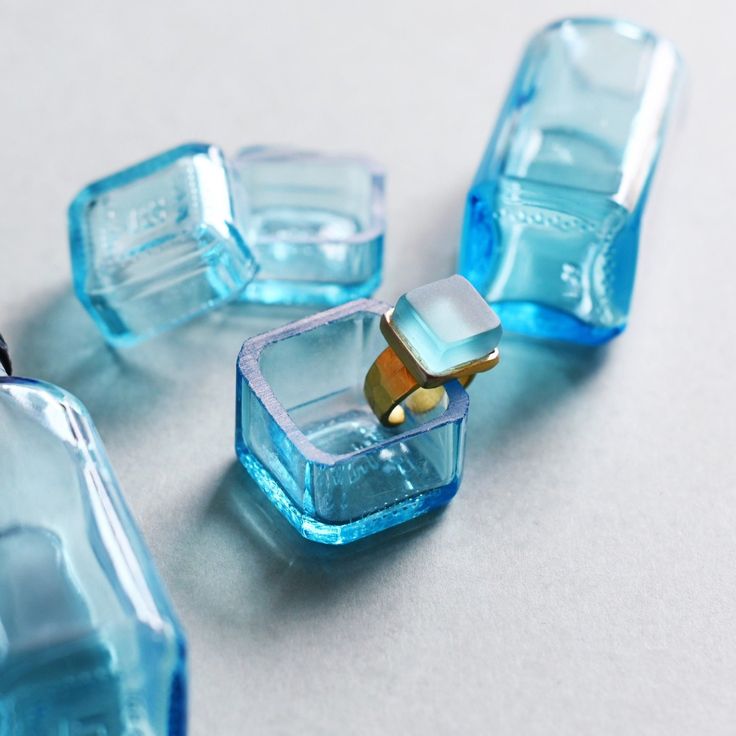 several blue glass objects on a white surface