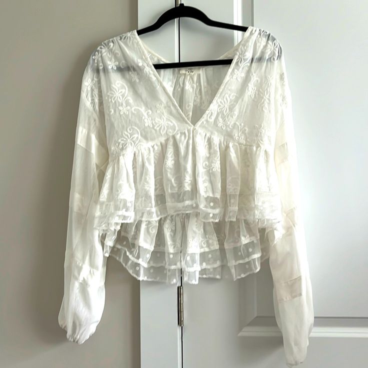 Nwot. White Lace, Cropped Blouse. Long Sleeves, Sheer See-Through Material. Mixed Details: Floral (Bodice), Polka Dots (Bottom Hem), And Lines (Sleeves). Deep V Neck. Never Worn, Recommend For Smaller Chest Women. White V-neck Blouse With Lace Top, Chic Lace V-neck Tops, Lace Long Sleeve Tops For Daywear, Lace Long Sleeve Tops For Day Wear, Lace Top With Long Sleeves For Daytime, Lace Top With Long Sleeves For Daywear, Feminine Long Sleeve Lace Top For Day Out, Chic Lace Blouse For Day Out, Lace Long Sleeve Blouse For Brunch