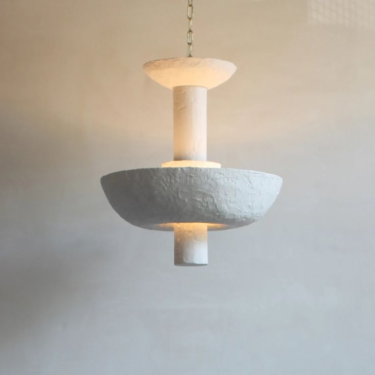 a concrete light fixture hanging from a ceiling