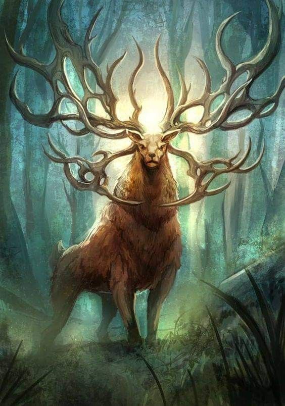 the deer is standing in the woods with his antlers spread out to its head