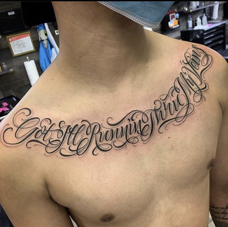 a man's chest is covered with lettering