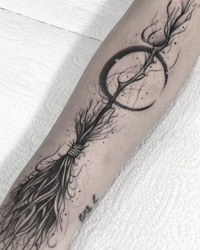 a black and white photo of a person's leg with a tattoo on it