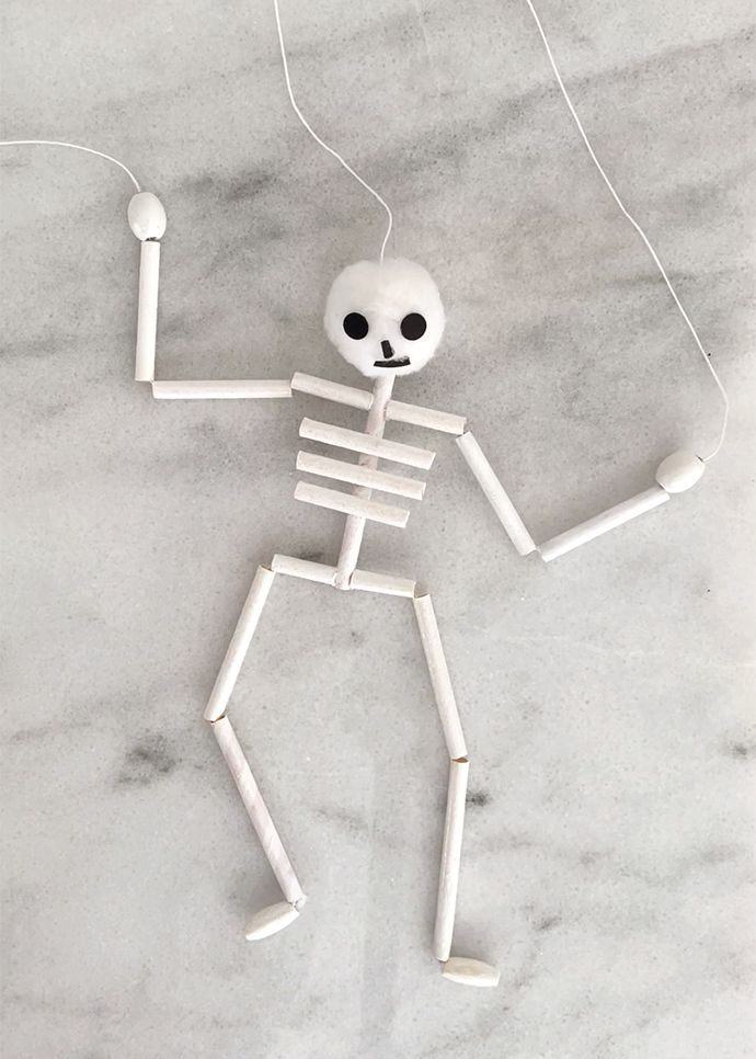 a skeleton with headphones hanging from it's neck on a marble surface in the shape of a human