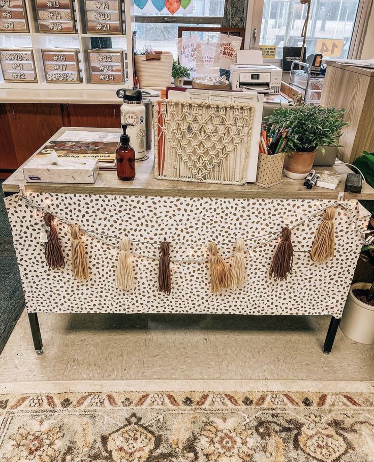 a table that has some items on top of it in front of a window with balloons