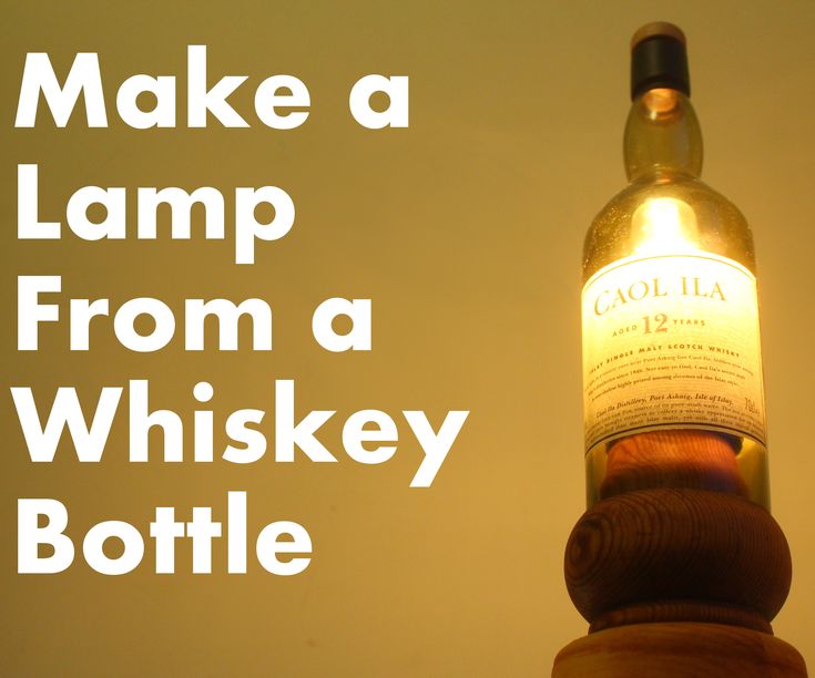 a bottle that is sitting on top of a wooden pole with the words make a lamp from a whiskey bottle