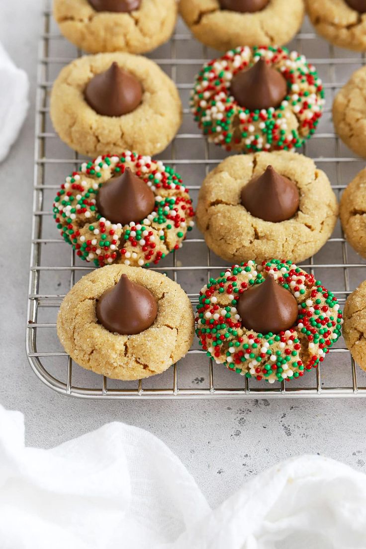 chocolate chip cookies with sprinkles and candy on a cooling rack, ready to be eaten