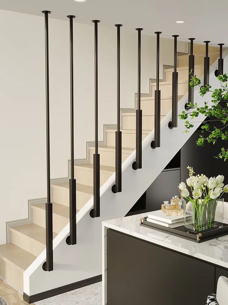 there is a vase with flowers on the table next to the stair case in this modern home