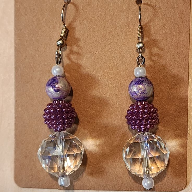 Add some sparkle to your outfit with these elegant Purple Drop Earrings. These earrings feature stunning faceted beads in shades of purple, complemented by shimmering crystal accents. Perfect for a night out or adding a touch of glamour to your everyday look, these earrings are sure to catch the eye. The drop style is both elegant and versatile, making them the perfect addition to any jewelry collection. Crafted from high-quality materials, these earrings are designed for durability and long-lasting wear. The beautiful color combination is sure to complement any outfit - from casual jeans and a tee shirt, to an elegant evening gown. Make a statement with these stunning Purple Drop Earrings - perfect for adding some sparkle and shine! Purple Beaded Earrings For Party, Faceted Crystal Party Earrings, Purple Faceted Beads Jewelry For Party, Purple Jewelry With Faceted Beads For Party, Adjustable Crystal Earrings With Faceted Beads, Elegant Faceted Beaded Drop Earrings, Elegant Lavender Beaded Drop Earrings, Elegant Lavender Beaded Earrings, Purple Faceted Beaded Round Earrings