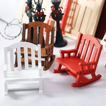 miniature wooden rocking chairs sitting next to each other