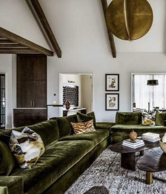 a living room filled with lots of green furniture