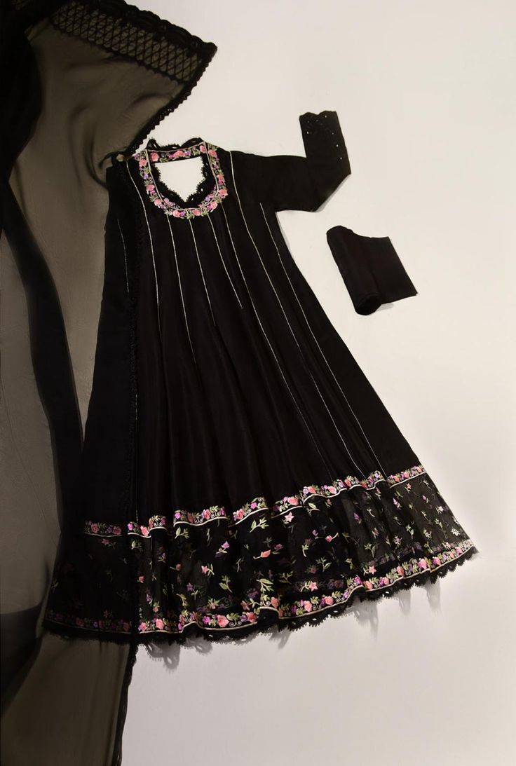 This beautiful three piece is designed on pure jet black cotton net, in a panelled flowy angrakha silhoutte, with pretty hand embroidered floral details, crochet laces alongside hand sewn sheesha on sleeves. Paired with a pretty dupatta and pencil trousers. The length of the long angrakha is 48 inches. An alluring desi Anarkali Set With Lace Work For Designer Wear, Anarkali Sets With Lace Work, Designer Semi-stitched Lace Anarkali Set, Semi-stitched Lace Work Anarkali Set For Designer Wear, Party Anarkali Kurta With Lace Work, Party Anarkali Set With Lace Work And Traditional Drape, Anarkali Kurta With Lace Work For Party, Anarkali Lace Work Salwar Kameez For Designer Wear, Designer Anarkali Salwar Kameez With Lace Work