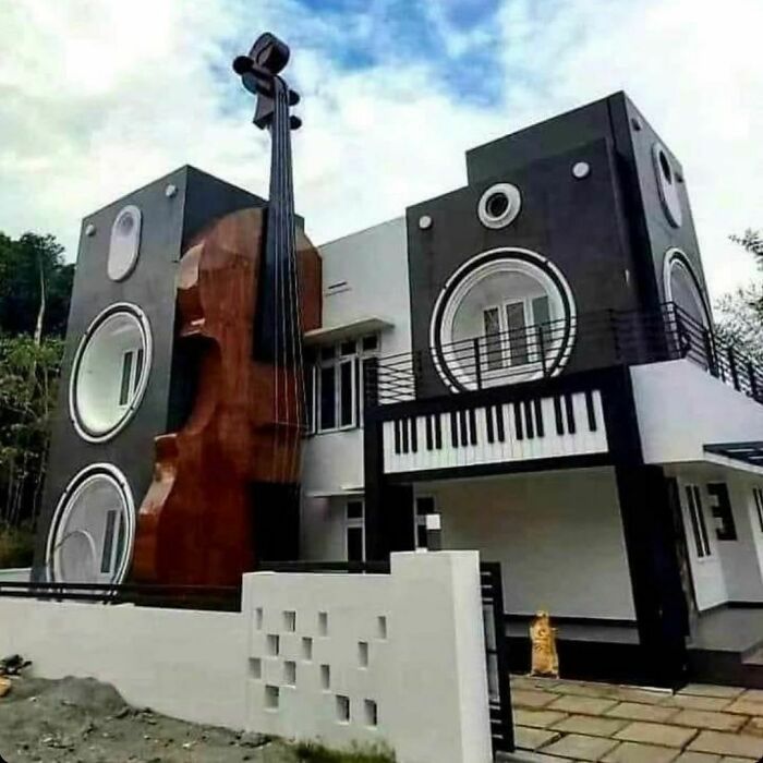 a large building with a giant instrument on the front and side of it's face