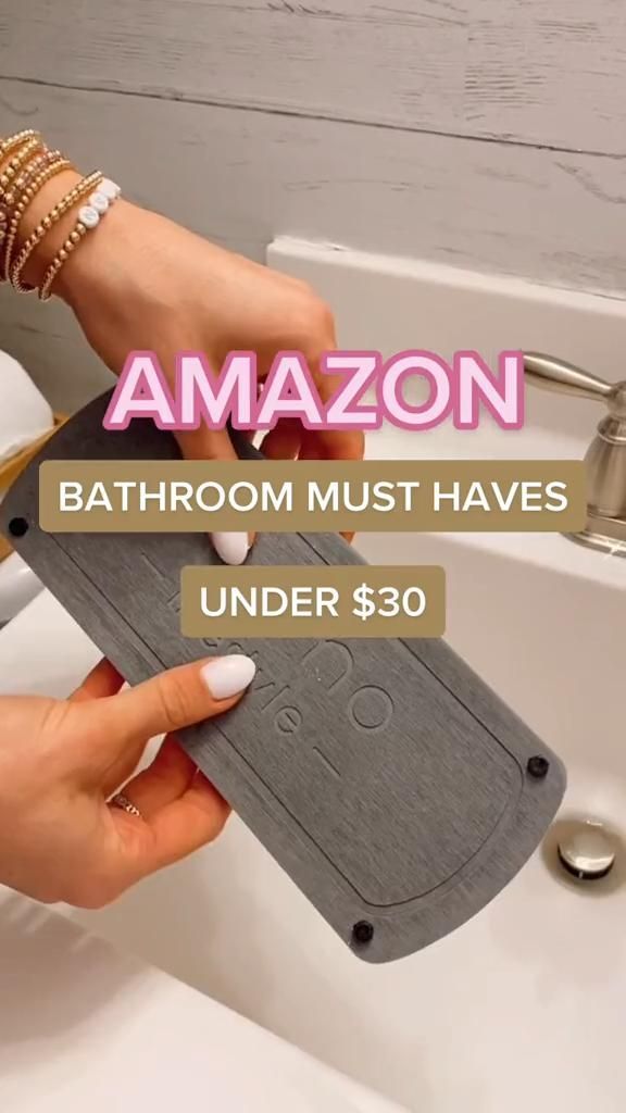 a woman is cleaning her bathroom sink with the words, amazon bathroom must have under $ 30