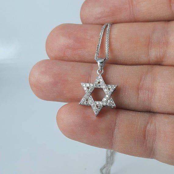 A classic interwoven star of David pendant necklace, made of solid 14k white/yellow gold, set with natural sparkling diamonds. The piece is handmade in our workshop. This unique David star pendant can be an ideal gift for Bar/Bat mitzvah, Birthday, Anniversary, Jewish holiday or any meaningful occasion.* Packed in an elegant jewelry box.* Get free worldwide shipping.* Appraisal certificate is included for the authenticity of the gold and diamonds.* We offer payment plans* If you like our designs Silver Diamond Star Of David Necklace, Silver Diamond Necklace In Star Of David Shape, Star Of David Necklace In Cubic Zirconia As Gift, White Gold Diamond Necklace Star Of David Gift, Sterling Silver Star Diamond Necklace, Star-shaped Cubic Zirconia Diamond Necklace Gift, Silver Cubic Zirconia Star Of David Jewelry, White Gold Cubic Zirconia Star Of David Jewelry, Diamond White Star Of David Jewelry Gift