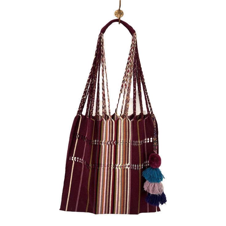 We have brought the quintessential Mexican striped hammock bag with pom pom home with us in an array of enticing colors. The woven yarns in the purse are braided to become the straps that lead up to a comfortable finished shoulder strap. This is the purse that your friends will be asking where you got it! Hand selected and imported from Guanajuato, Mexico. Entirely handwoven on traditional Maya looms, it takes an artisan an entire days worth of weaving to complete one striped hammock bag. • Doub Striped Woven Rectangular Shoulder Bag, Rectangular Striped Woven Shoulder Bag, Striped Woven Tote Bag, Handwoven Striped Bags For Everyday Use, Everyday Handwoven Striped Bags, Pom Pom Fashion, Hammock Bag, Black Candy, Striped Bags