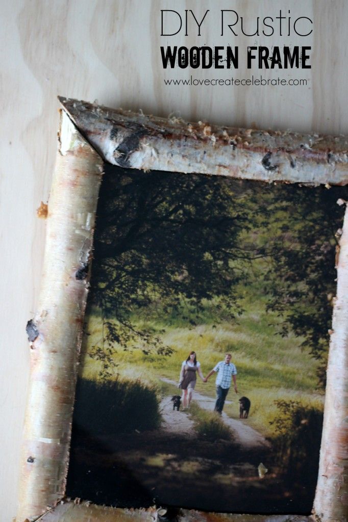 an old wooden frame is hanging on the wall with two people and a dog in it