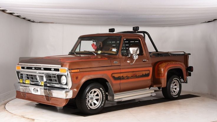 an old pickup truck is parked in a white room with a canopy over the bed