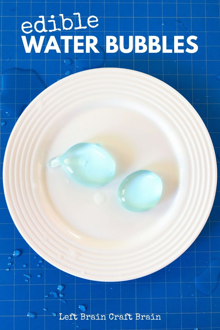 two blue eggs sitting on top of a white plate