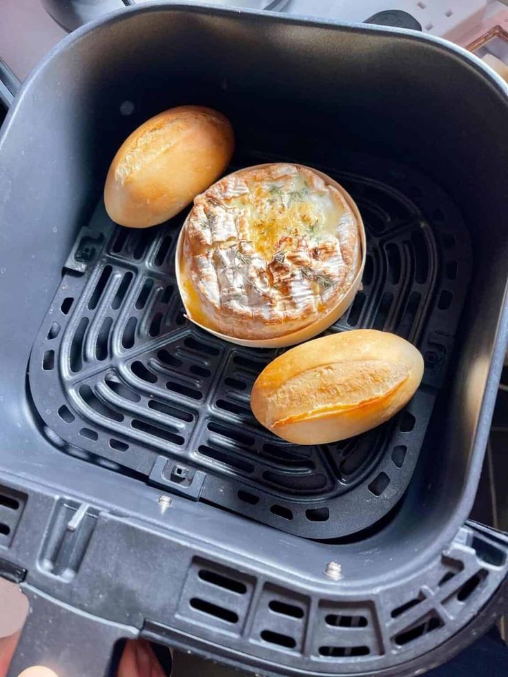 two breads sitting on top of an air fryer