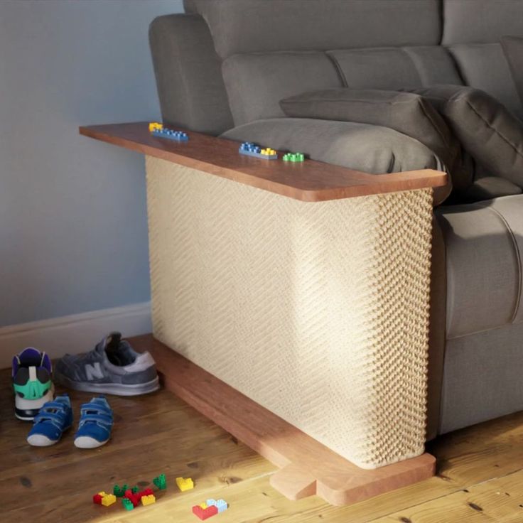 a couch with legos sitting on the floor next to it's foot rest