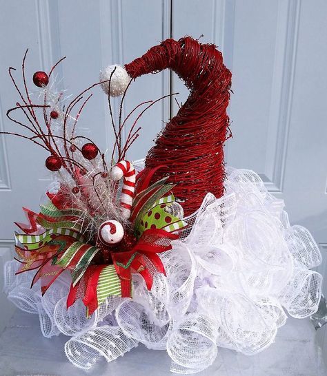 a red and white christmas decoration in a basket